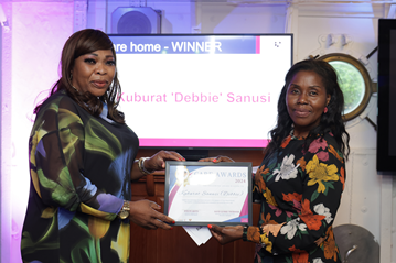 Cllr Akoto presents a certificate to Debbie Sanusi